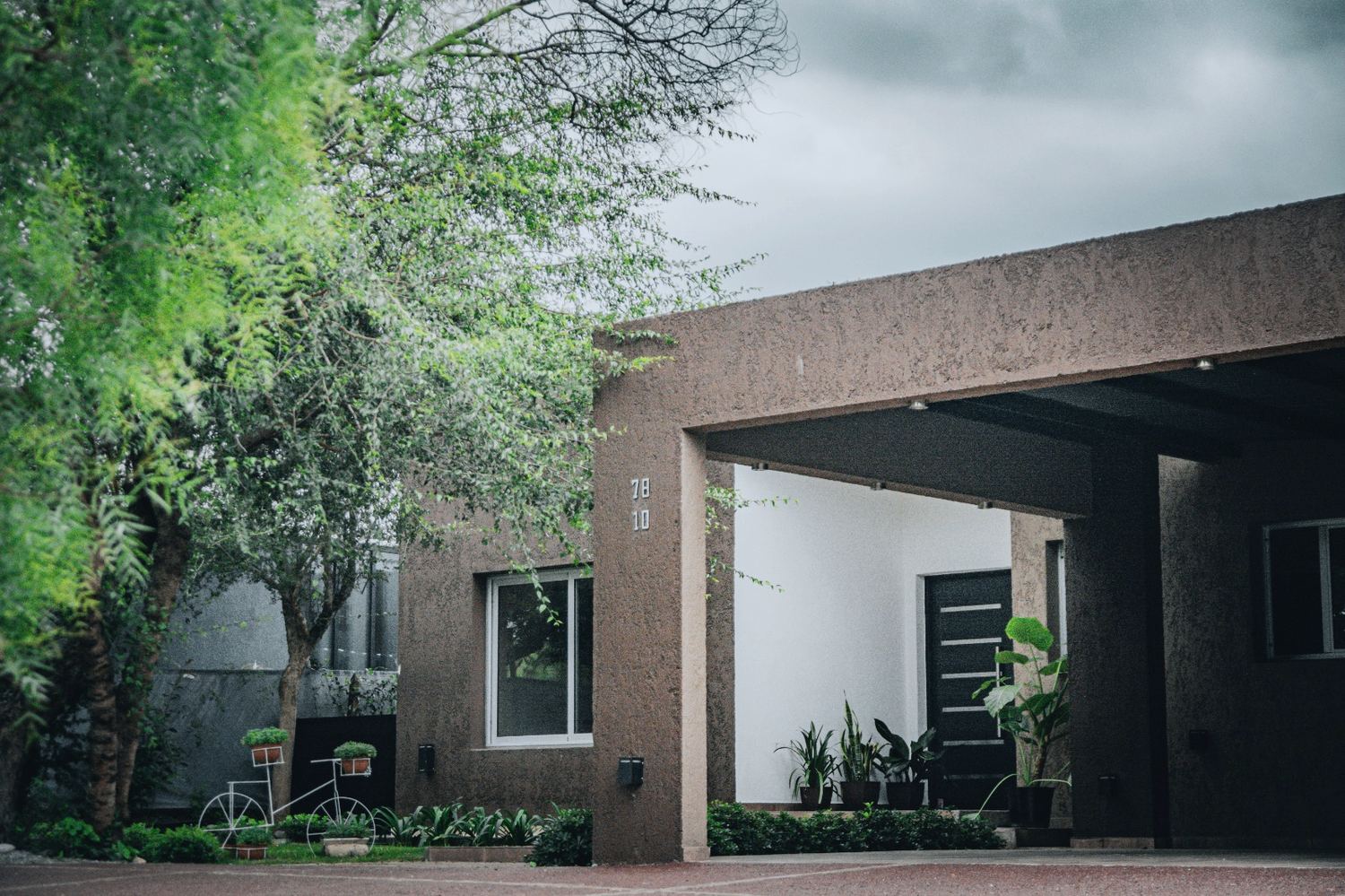 Casa de volumen oscuro entre árboles